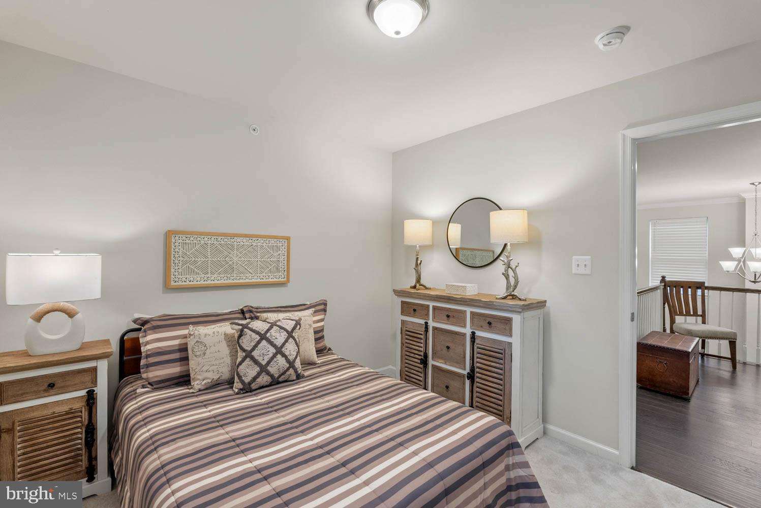 17883 Sugarberry Road Dumfries, VA 22026 - Photo 35 of 53 a bedroom with a bed and a chandelier