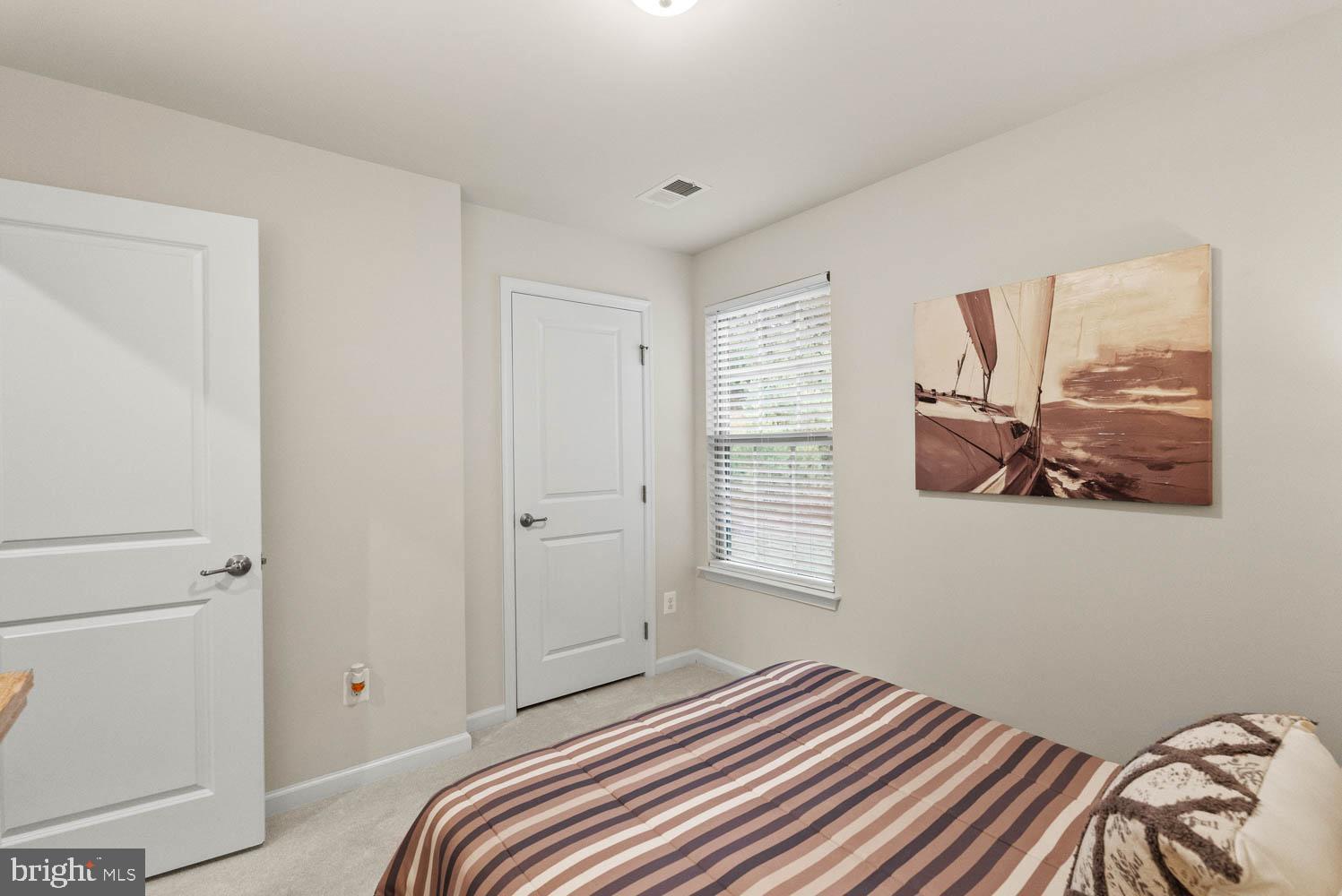 17883 Sugarberry Road Dumfries, VA 22026 - Photo 37 of 53 a bedroom with a bed and a window