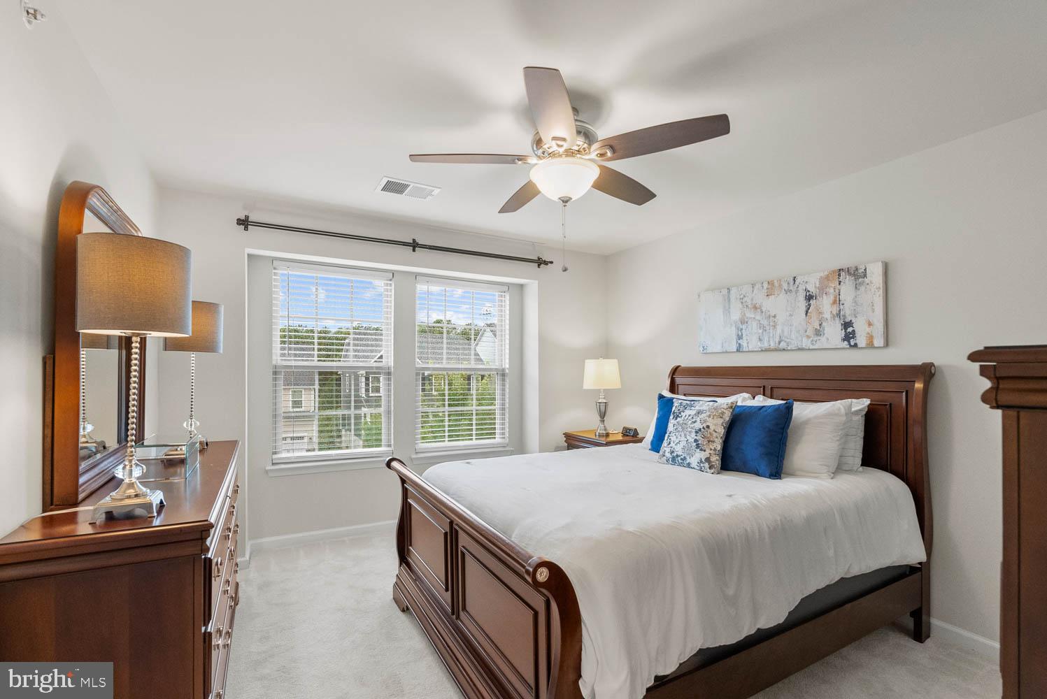 17883 Sugarberry Road Dumfries, VA 22026 - Photo 38 of 53 a bedroom with a large bed and a flat tv screen on dresser
