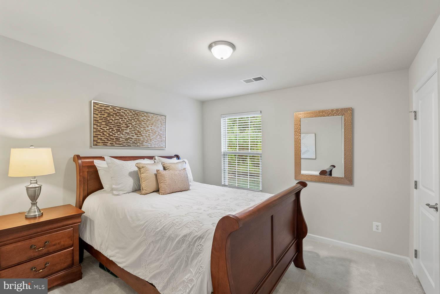 17883 Sugarberry Road Dumfries, VA 22026 - Photo 40 of 53 a bed room with a bed and a lamp