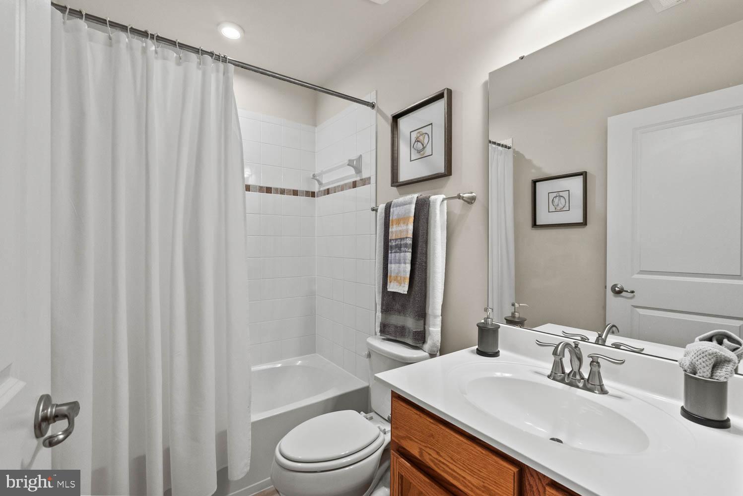 17883 Sugarberry Road Dumfries, VA 22026 - Photo 42 of 53 a bathroom with a sink a toilet and shower