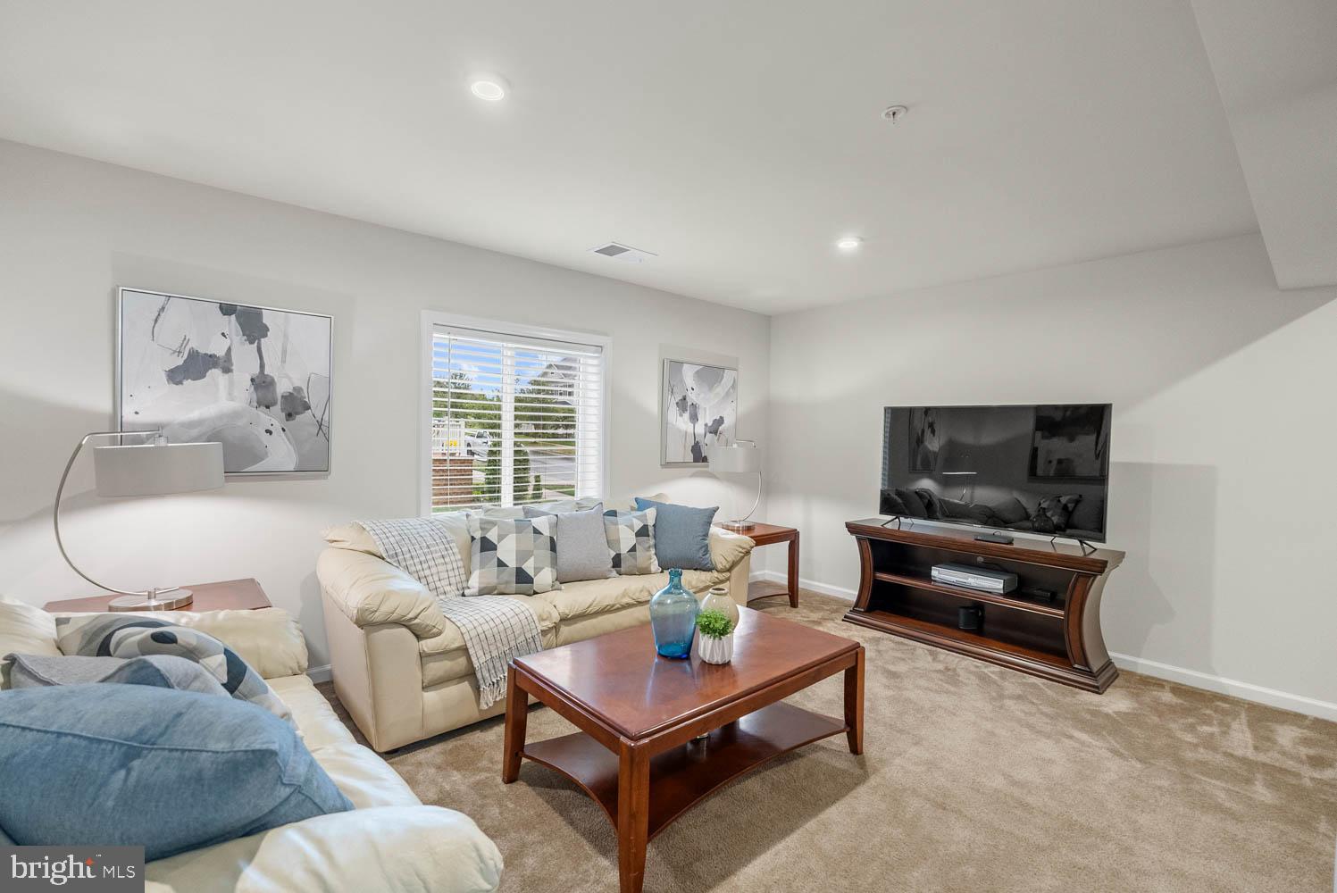 17883 Sugarberry Road Dumfries, VA 22026 - Photo 48 of 53 a living room with furniture and a flat screen tv