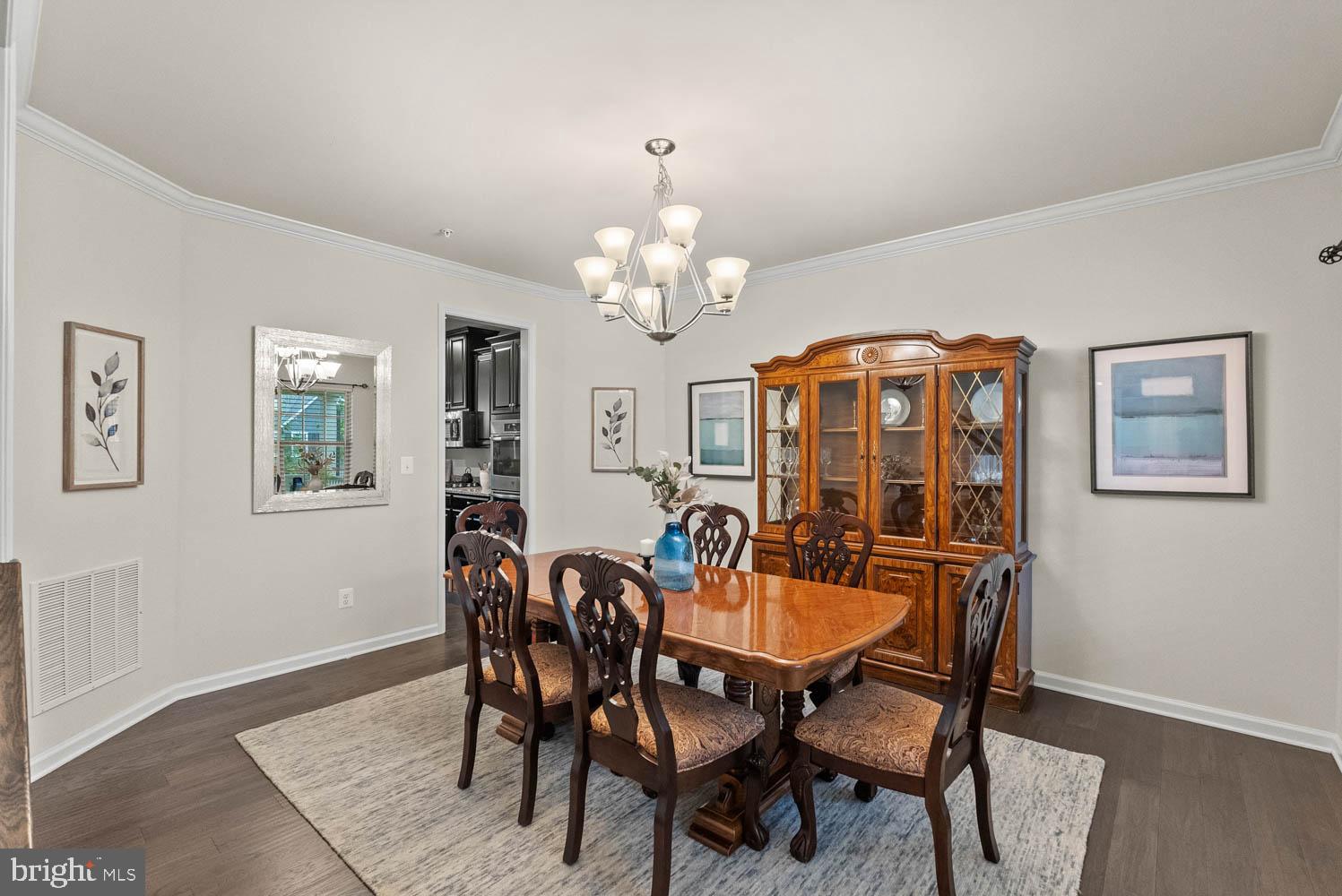 17883 Sugarberry Road Dumfries, VA 22026 - Photo 9 of 53 a view of a dining room with furniture and chandelier