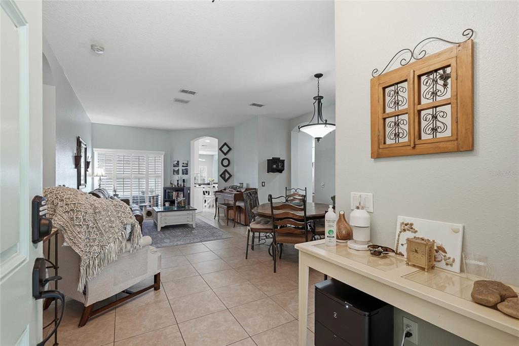 16748 Midsummer Lane Spring Hill, FL 34610 - Photo 6 of 52 a living room with furniture and view of kitchen