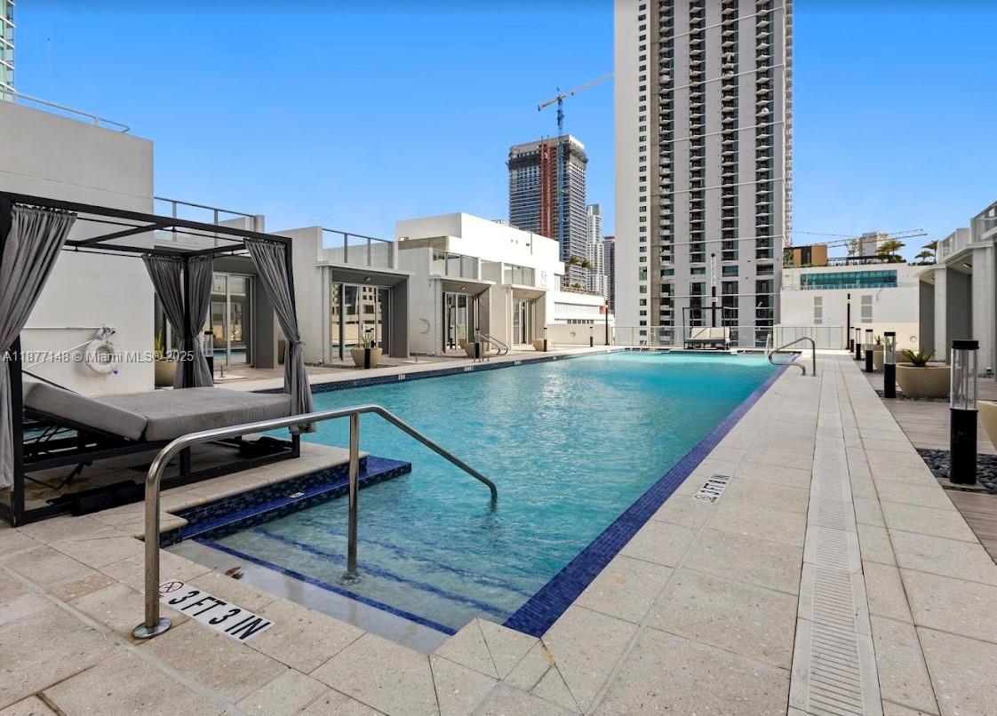 851 Northeast 1st Avenue, Unit 302 Miami, FL 33132 - Photo 13 of 30 a view of a patio with a table and chairs