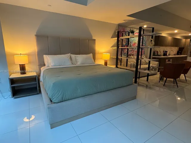 a bedroom with a bed and dresser