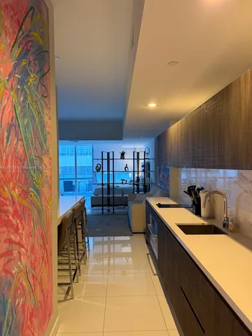 a kitchen with stainless steel appliances kitchen island granite countertop a sink and cabinets