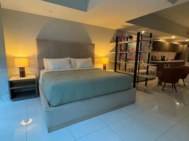 a bedroom with a bed and a chair