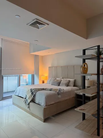a spacious bedroom with a bed and window
