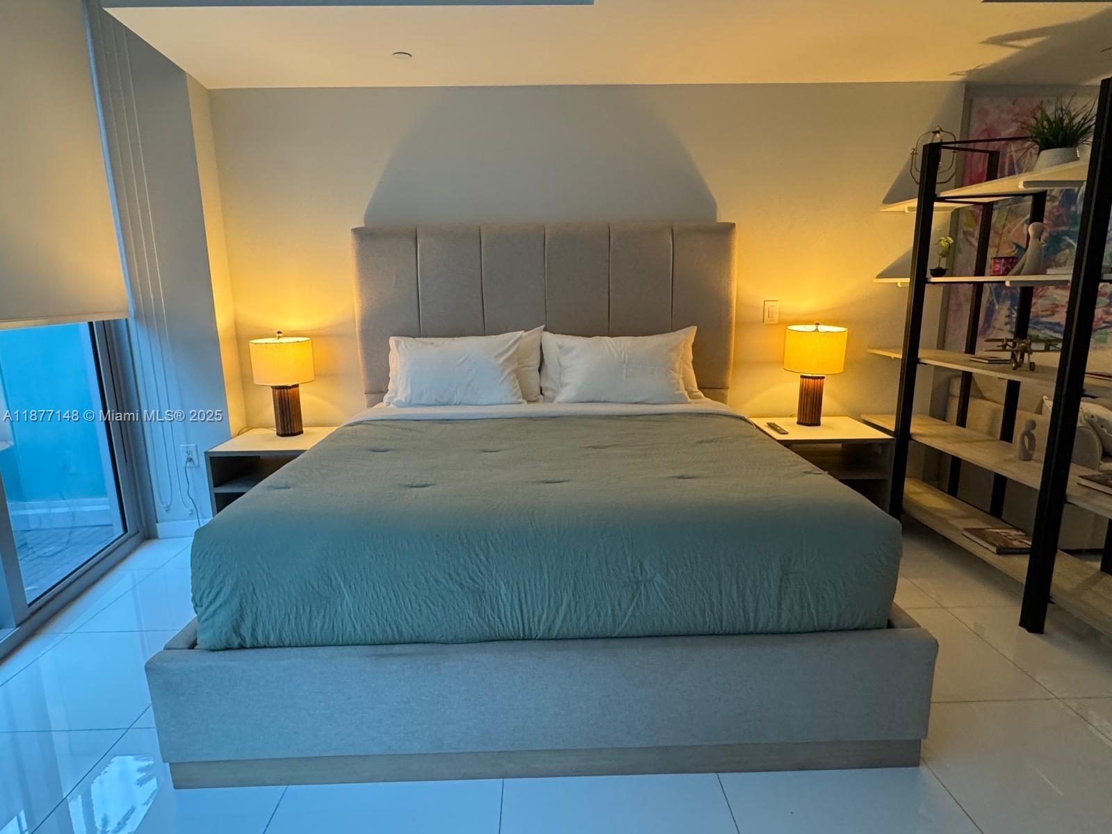 851 Northeast 1st Avenue, Unit 302 Miami, FL 33132 - Photo 28 of 30 a bedroom with a bed and a closet