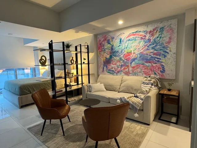 a living room with furniture and wall paintings