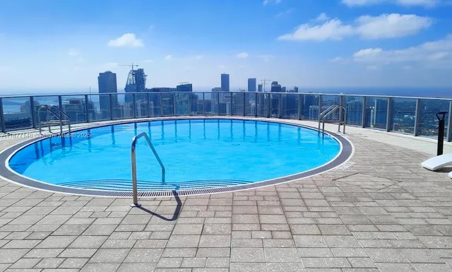 a view of a swimming pool with a yard
