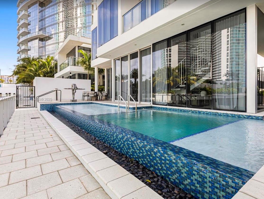 851 Northeast 1st Avenue, Unit 302 Miami, FL 33132 - Photo 9 of 30 a view of a swimming pool with a patio