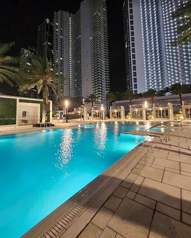 a swimming pool with outdoor seating