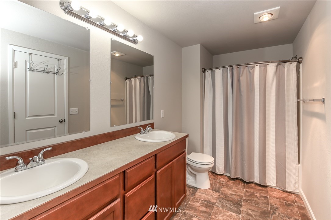 36313 Allen Road South Roy, WA 98580 - Photo 18 of 20 a bathroom with a double vanity sink and a mirror