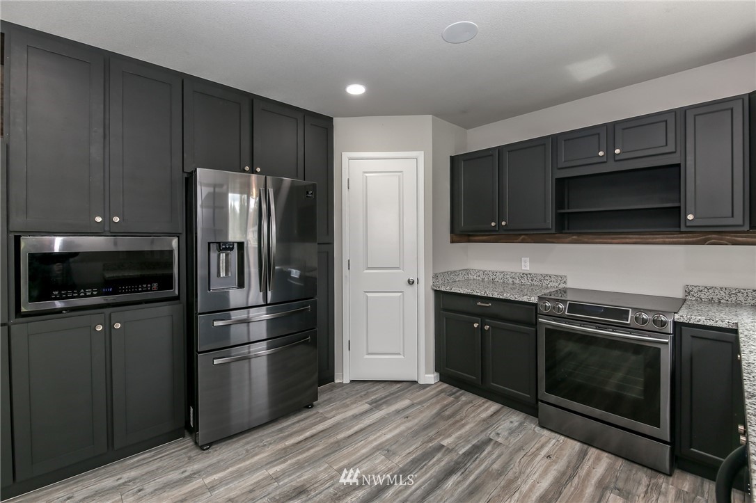 36313 Allen Road South Roy, WA 98580 - Photo 6 of 20 a kitchen with a refrigerator stove and microwave
