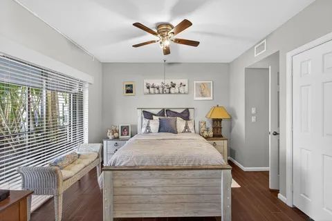 a bathroom with a granite countertop sink toilet a mirror and shower