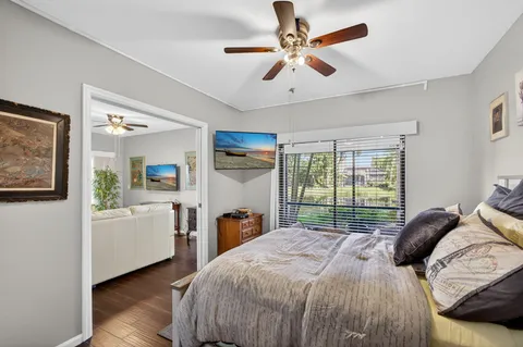 a bedroom with a bed and wooden floor
