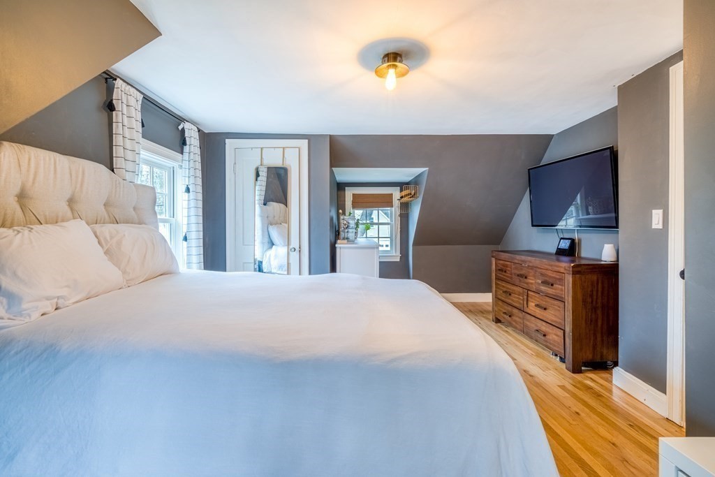 49 Jean Street Framingham, MA 01701 - Photo 15 of 41 a bedroom with a large bed and a flat tv screen on dresser