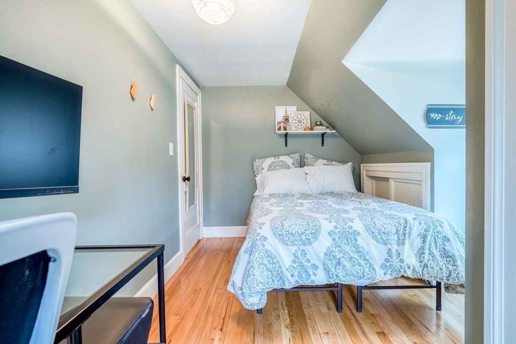 49 Jean Street Framingham, MA 01701 - Photo 21 of 41 a bedroom with a bed and a chandelier