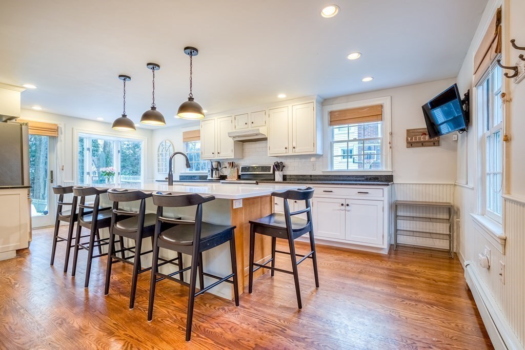 49 Jean Street Framingham, MA 01701 - Photo 4 of 41 a kitchen with stainless steel appliances kitchen island granite countertop a table chairs and a stove