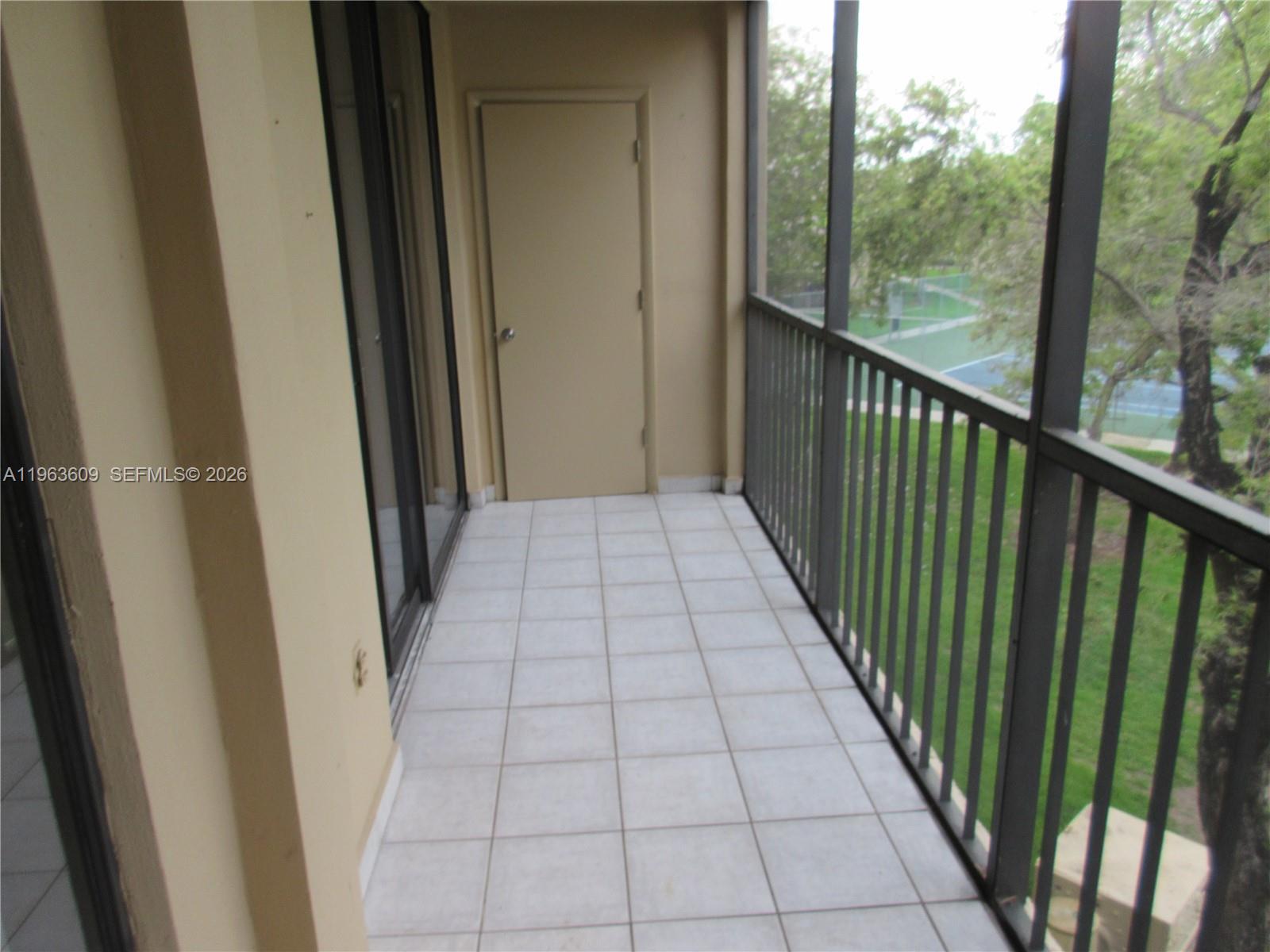 8025 Southwest 107th Avenue, Unit 321 Miami, FL 33173 - Photo 12 of 24 SCREENED BALCONY WITH STORAGE ROOM TILED