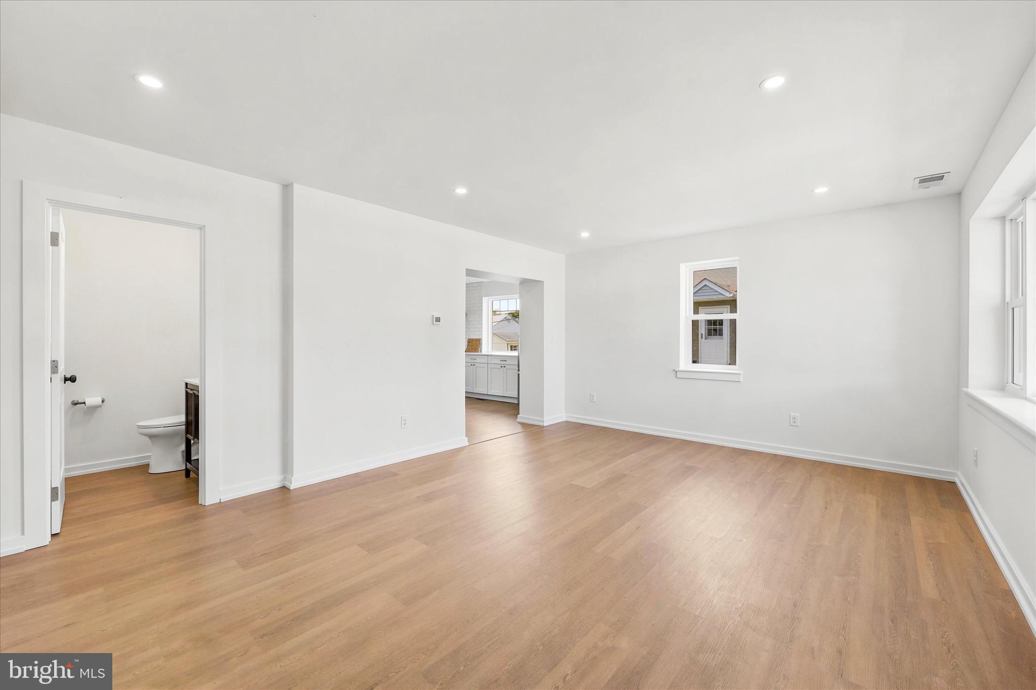 8 James Road Broomall, PA 19008 - Photo 5 of 35 a view of an empty room with wooden floor and a window