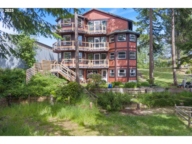 a view of a brick building next to a yard with a fountain
