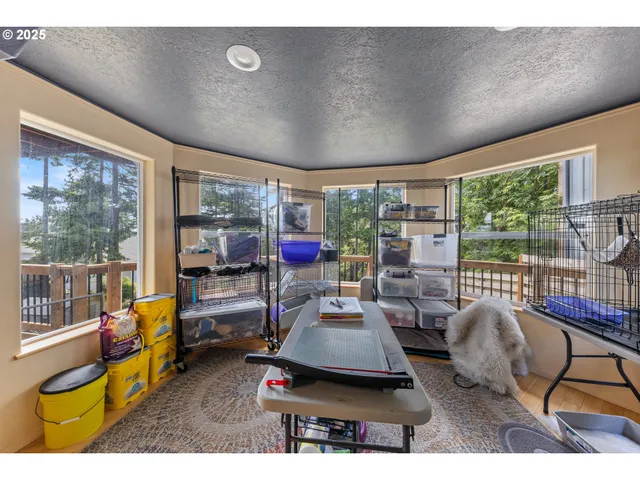 a view of a hallway with wooden floor and a living room