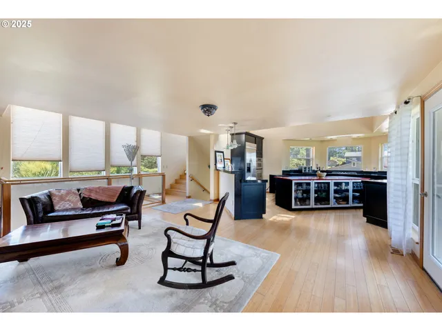 a living room with furniture and large windows