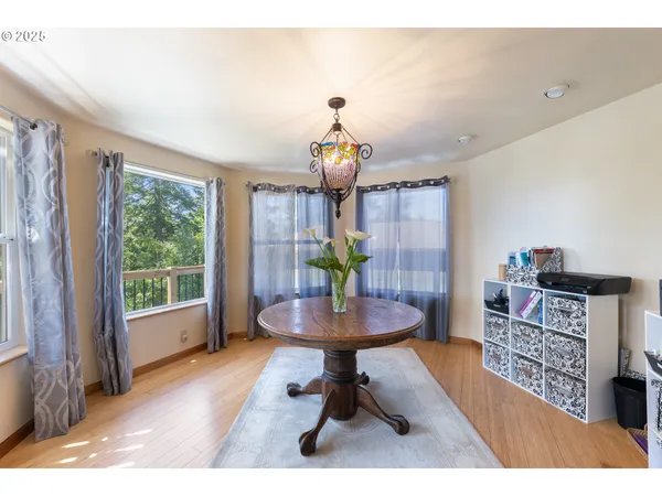 a kitchen with stainless steel appliances kitchen island granite countertop a sink dishwasher stove and cabinets with wooden floor