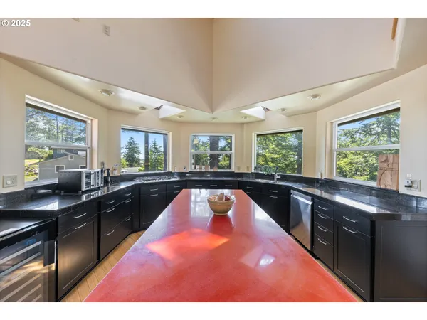 a kitchen with a stove a sink and a window
