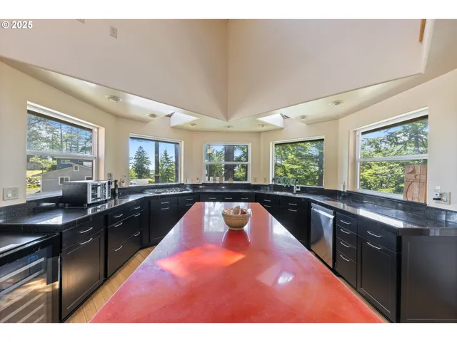 a kitchen with a stove a sink and a window