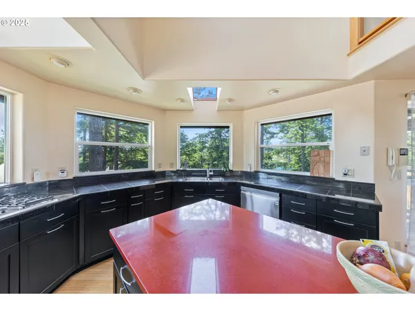 a spacious bedroom with a bed a dresser and large window