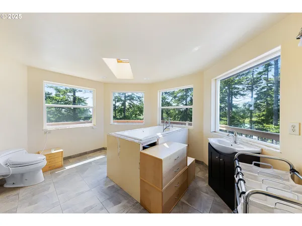 a view of a big room with large trees and plants