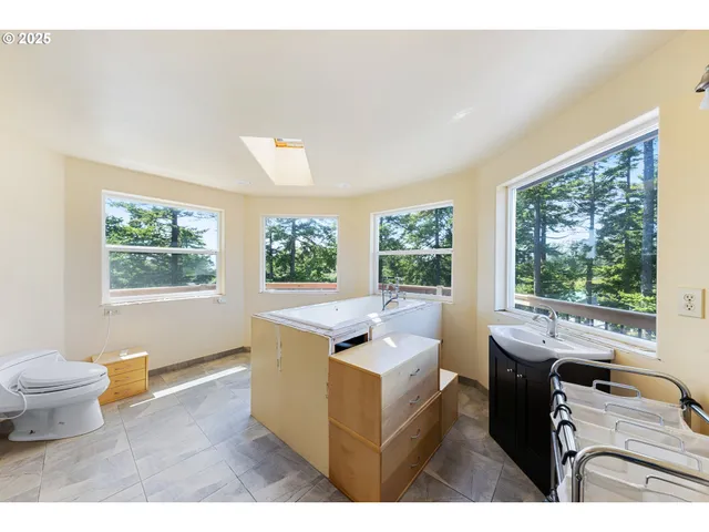 a view of a big room with large trees and plants