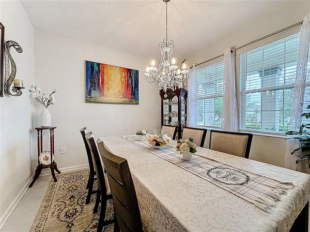 a view of a dining room with furniture and a chandelier