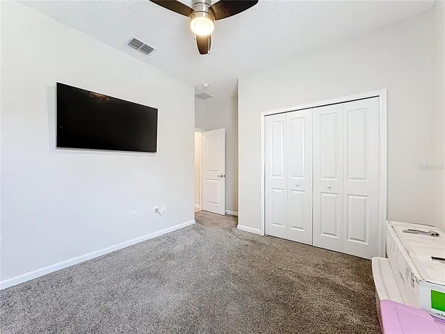 a view of an empty room with a flat screen tv