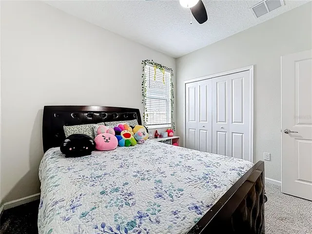 a bedroom with a bed and cabinets
