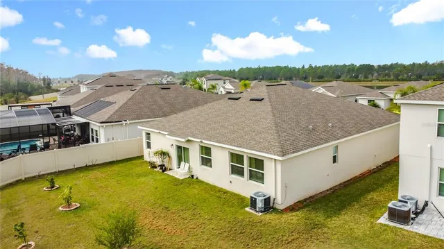 a aerial view of a house with a yard