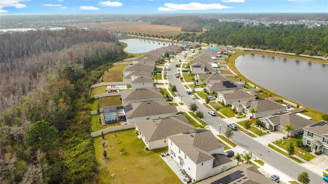 an aerial view of residential house with outdoor space and lake view