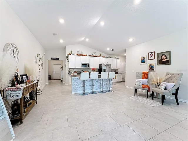 a living room with furniture and white cabinets