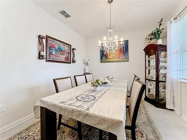 a view of a dining room with furniture and chandelier