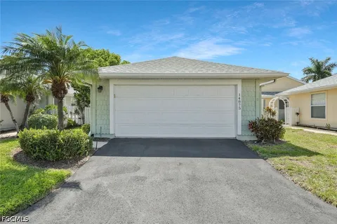 a front view of a house with a yard and a garage