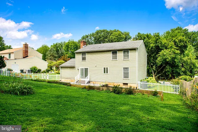 a view of a backyard with plants and a garden