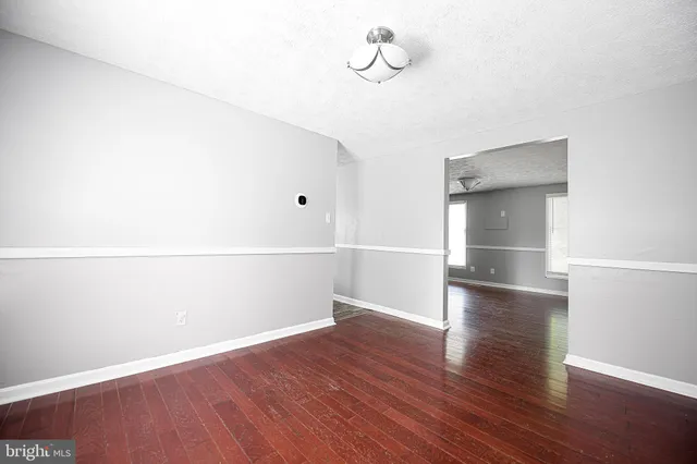 an empty room with wooden floor