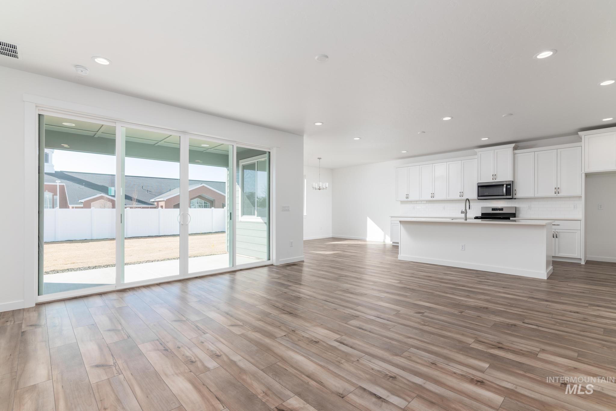 893 West Bay Street Middleton, ID 83644 - Photo 3 of 10 Unfurnished living room featuring suspended lighting and light wood finished floors