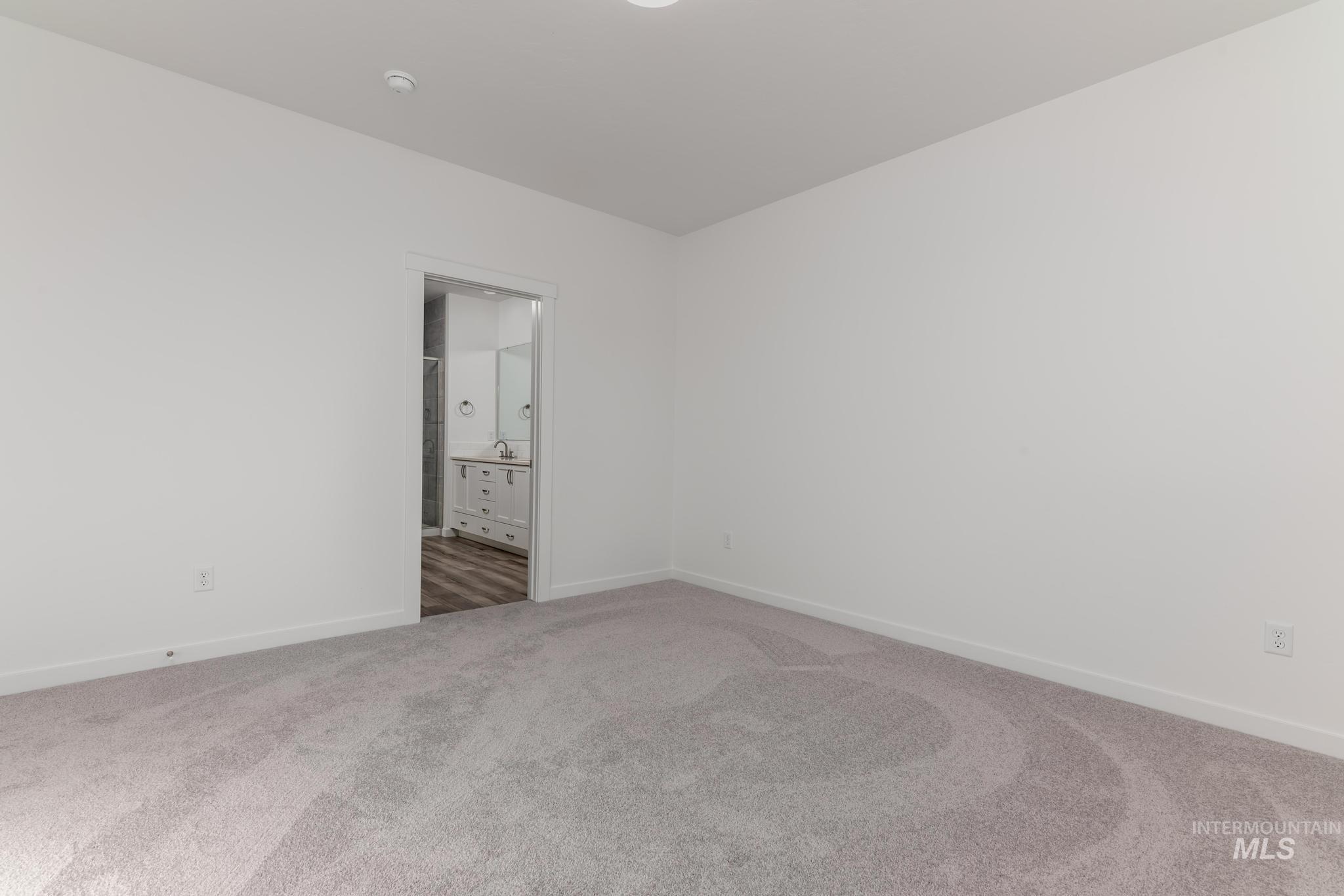 893 West Bay Street Middleton, ID 83644 - Photo 8 of 10 Unfurnished bedroom featuring connected bathroom and carpet floors