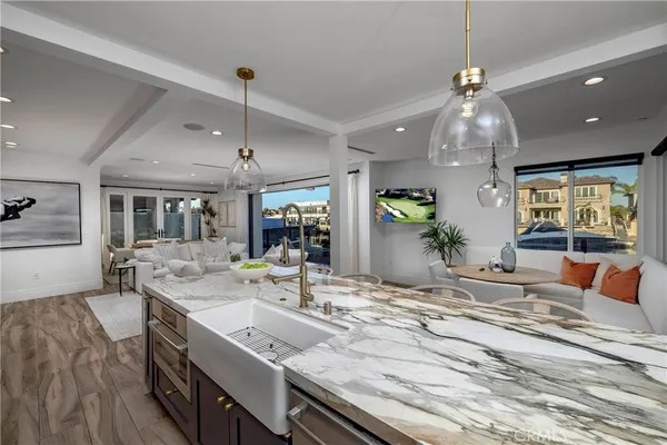 a bathroom with a granite countertop sink a toilet and mirror