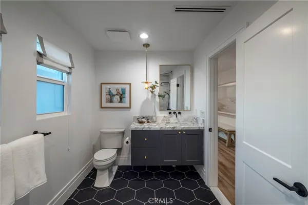 a living room with furniture kitchen and a table
